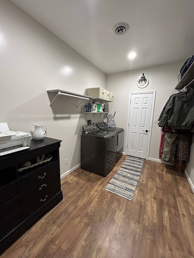 laundry room featuring separate washer and dryer and dark wood-type flooring