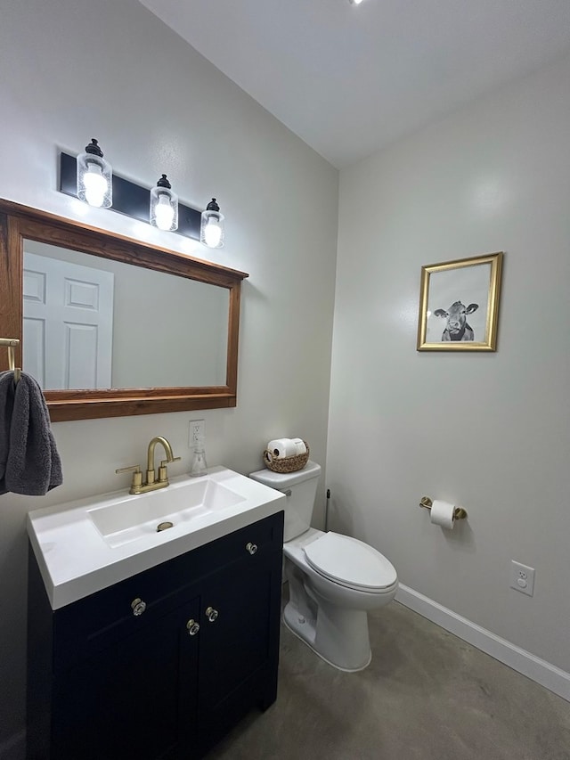 bathroom with vanity, toilet, and concrete floors