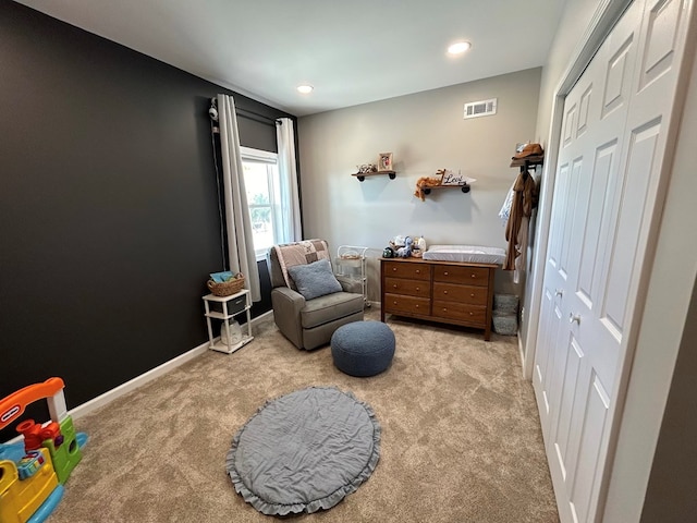 bedroom with light carpet and a closet