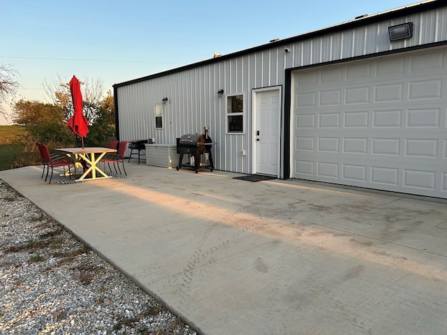 view of garage at dusk