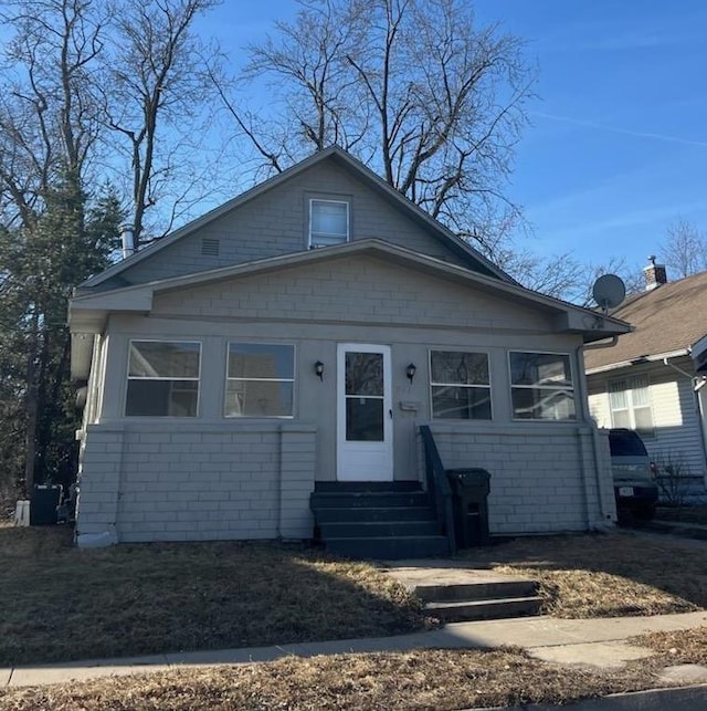 bungalow-style house with entry steps