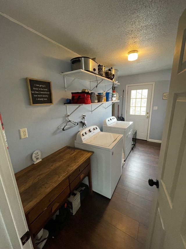 clothes washing area featuring a textured ceiling, laundry area, dark wood-style floors, and washing machine and clothes dryer