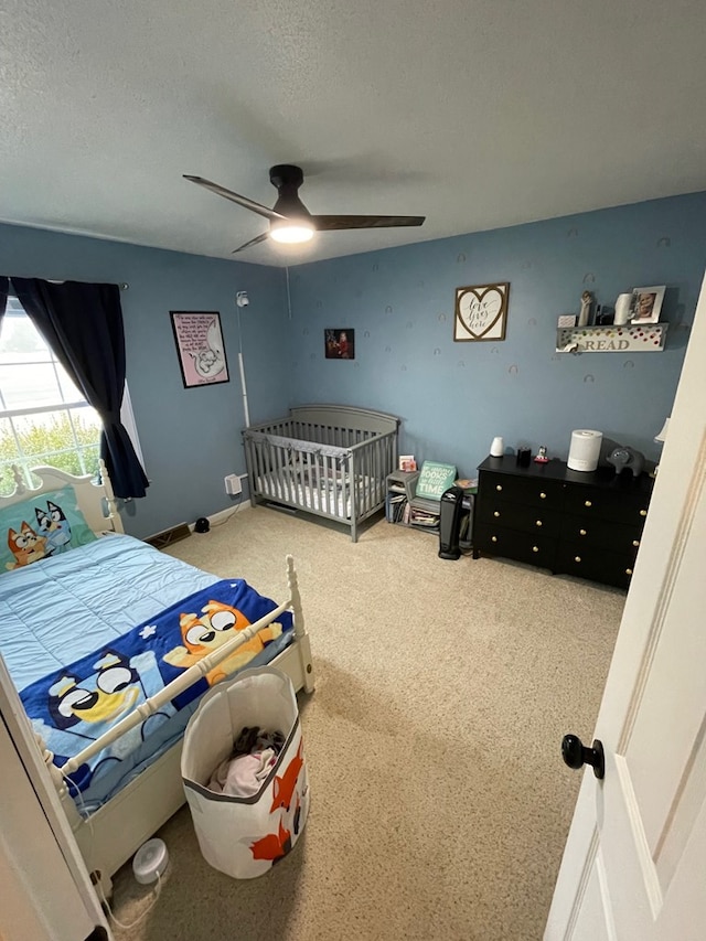 bedroom with a textured ceiling and a ceiling fan