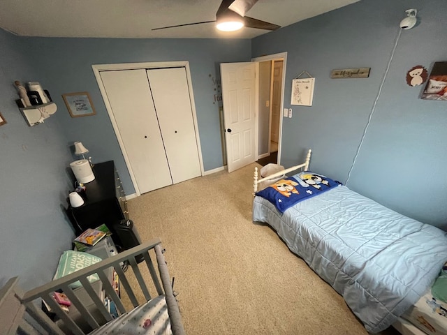 bedroom with a closet, ceiling fan, baseboards, and carpet