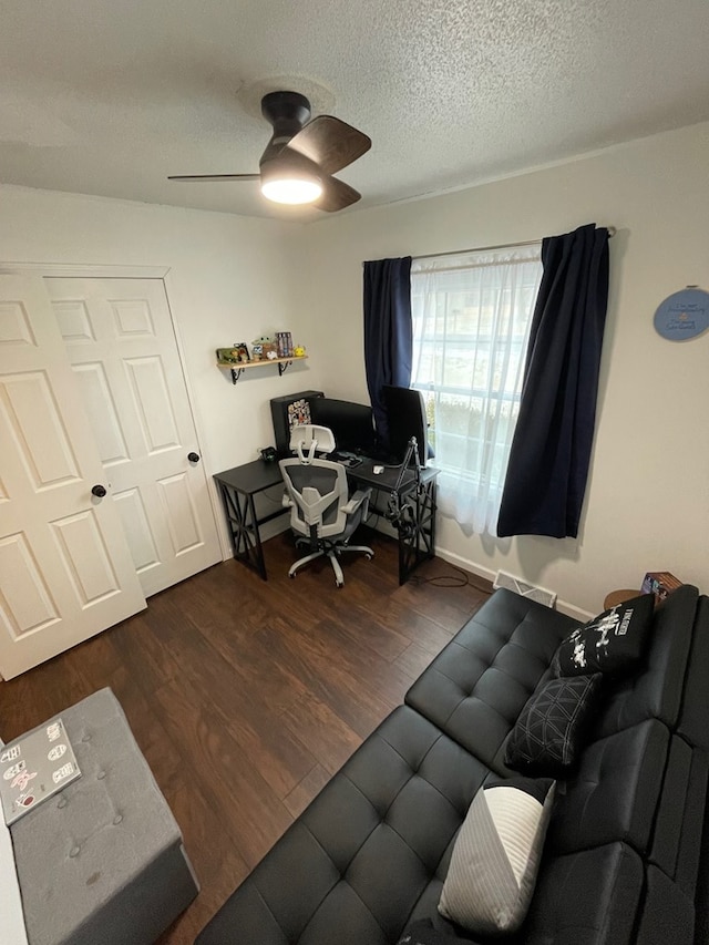 office area with a textured ceiling, a ceiling fan, and wood finished floors