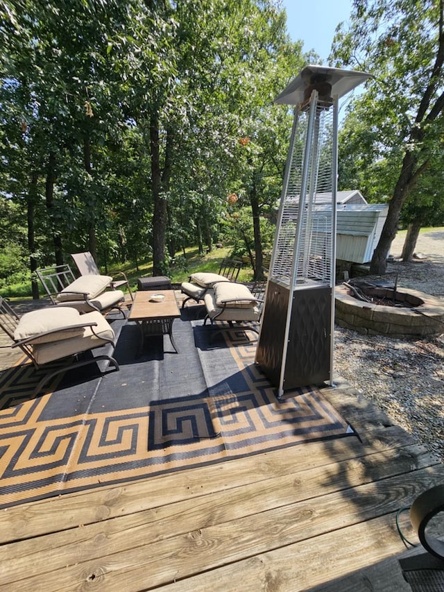 wooden deck featuring an outdoor fire pit