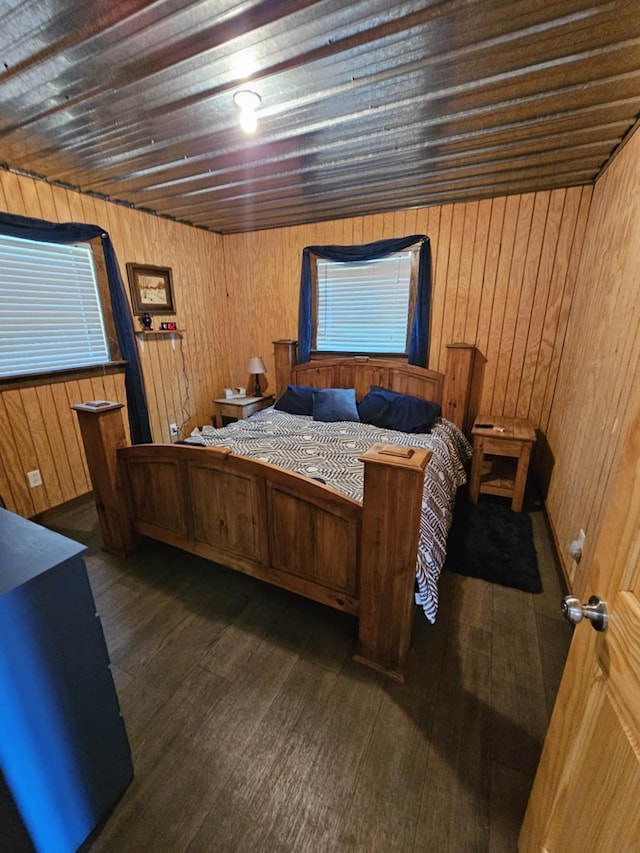 bedroom featuring dark hardwood / wood-style flooring, wooden ceiling, and wood walls