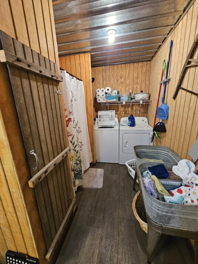 laundry area with wood ceiling, dark hardwood / wood-style flooring, washer and dryer, and wood walls