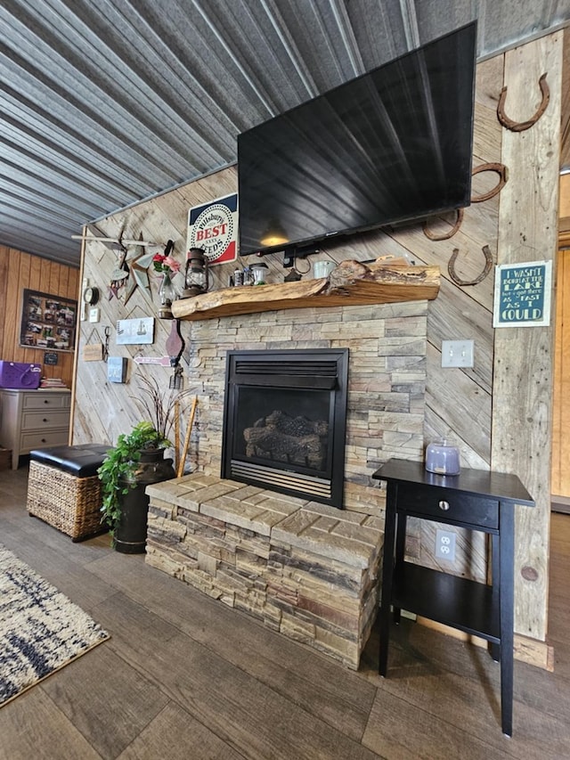 living room with a fireplace and wooden walls