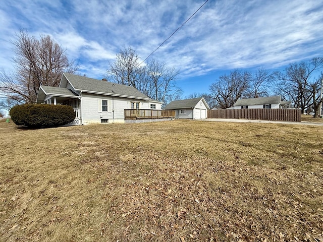 view of yard with an outdoor structure and fence