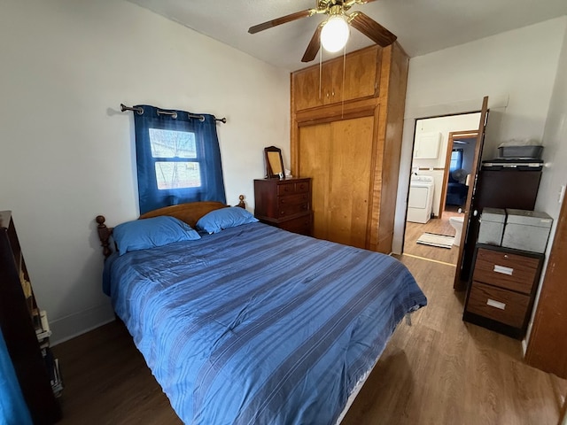 bedroom featuring washer / dryer, ceiling fan, baseboards, and wood finished floors