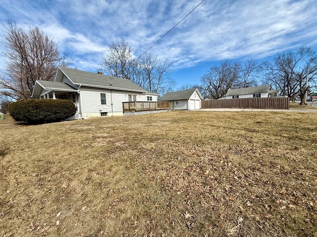 view of yard featuring fence and an outdoor structure