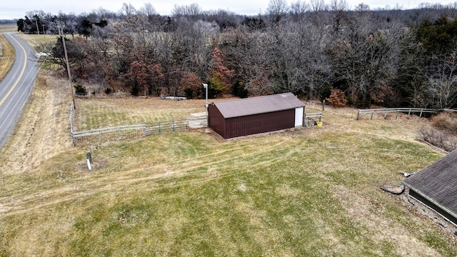 view of yard with a rural view and an outdoor structure