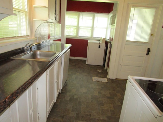 709 E Line St, Kirksville, MO 63501 - kitchen with dishwasher, range, white cabinets, and dark countertops