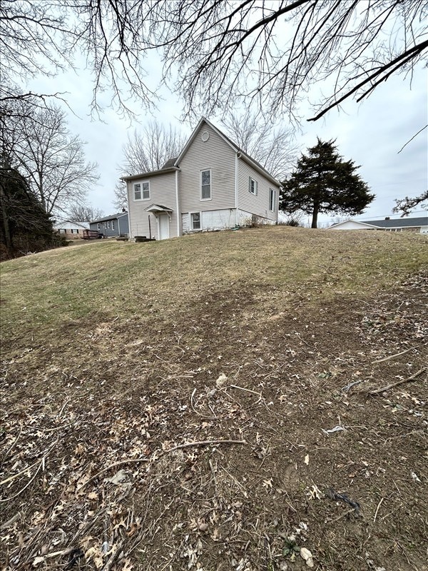 view of property exterior featuring a lawn