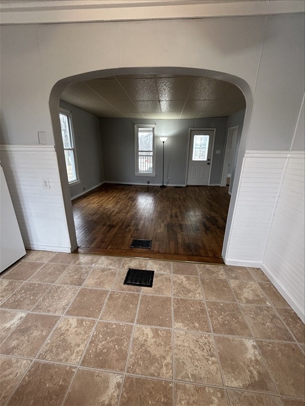 foyer entrance with hardwood / wood-style flooring and a paneled ceiling