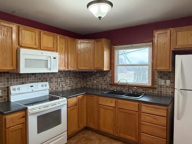 kitchen featuring sink, white appliances, and backsplash