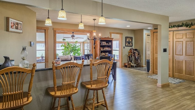 26831 State Highway 11, Kirksville, MO 63501 - dining area with a textured ceiling, baseboards, ceiling fan, and wood finished floors