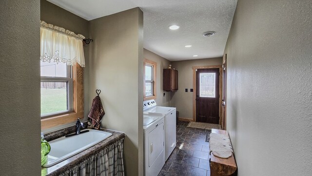 26831 State Highway 11, Kirksville, MO 63501 - clothes washing area with washer and clothes dryer, baseboards, a textured ceiling, visible vents, and stone tile flooring