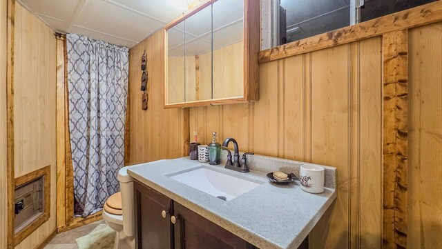 26831 State Highway 11, Kirksville, MO 63501 - full bathroom featuring a shower with curtain, toilet, wood walls, and vanity