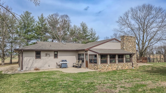 26831 State Highway 11, Kirksville, MO 63501 - rear view of house featuring a sunroom, a lawn, stone siding, a patio, and a chimney