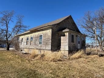 view of side of home featuring a yard