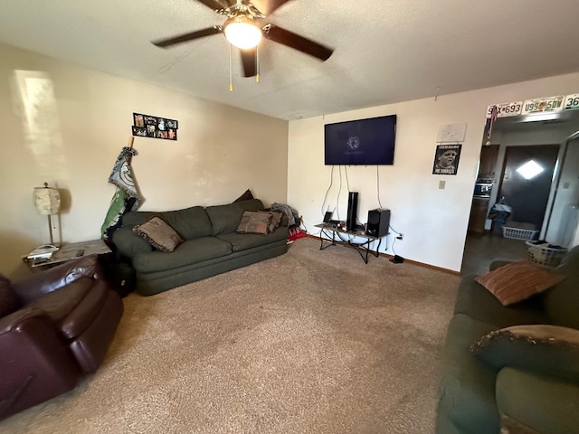living area featuring carpet floors, a textured ceiling, and ceiling fan
