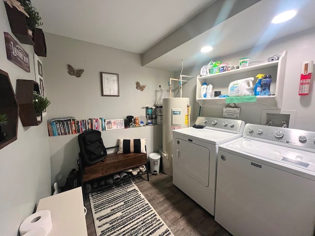 laundry area featuring washer and clothes dryer, dark wood-type flooring, and water heater