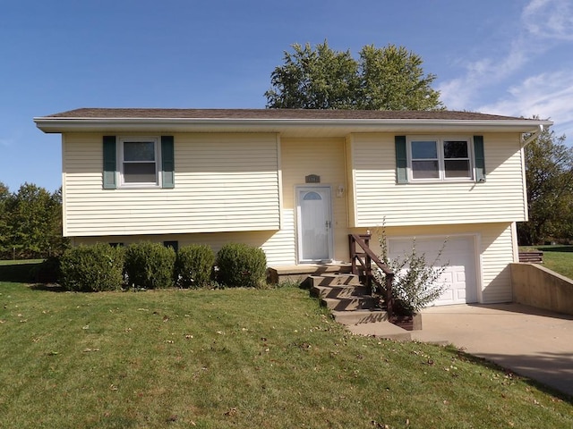 split foyer home featuring a garage and a front yard