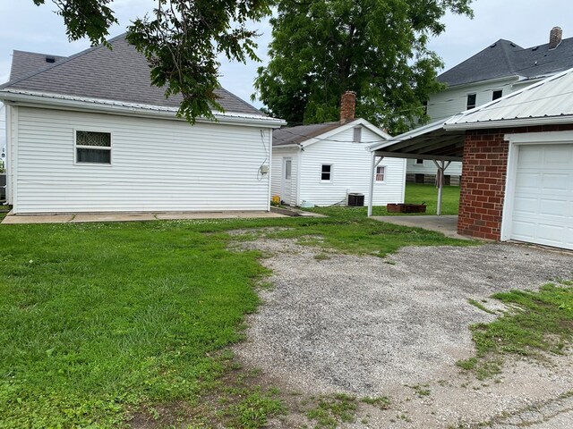 418 Elm St, Chillicothe, MO 64601 - back of property with central AC and a yard