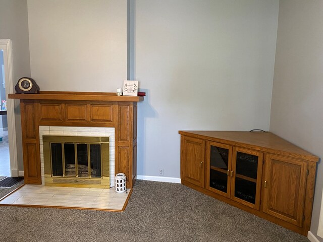 418 Elm St, Chillicothe, MO 64601 - unfurnished living room with carpet flooring, a tile fireplace, and baseboards