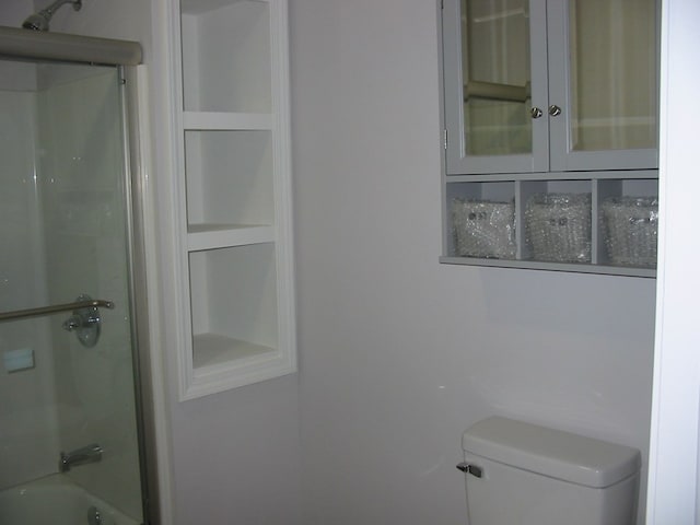 bathroom with shower / bath combination and toilet