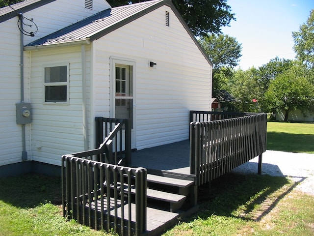 exterior space featuring a deck and a lawn