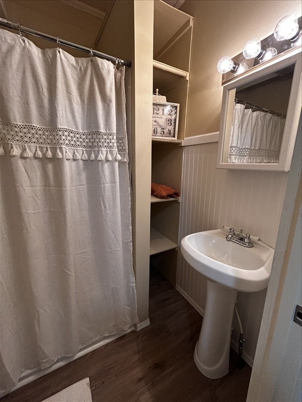 1617 N Church St, Marceline, MO 64658 - bathroom featuring wood finished floors, wainscoting, and curtained shower