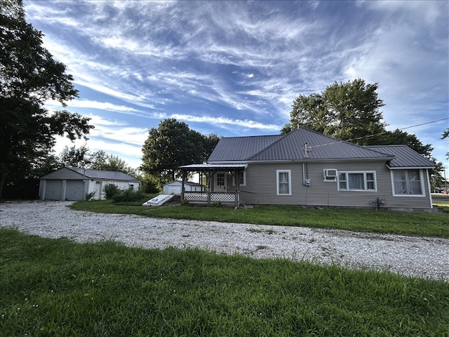 1617 N Church St, Marceline, MO 64658 - view of front of property featuring a front yard, a metal roof, and a garage