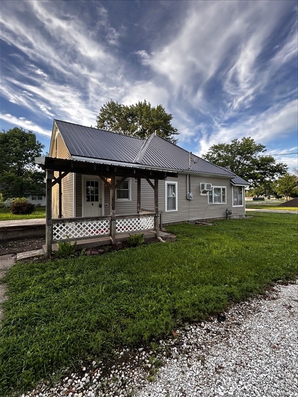 1617 N Church St, Marceline, MO 64658 - view of front of property with a metal roof, a front yard, and covered porch