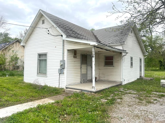 307 4th St, Ludlow, MO 64656 - back of house featuring covered porch and roof with shingles