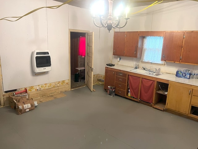 307 4th St, Ludlow, MO 64656 - kitchen featuring heating unit, brown cabinetry, a chandelier, finished concrete floors, and light countertops