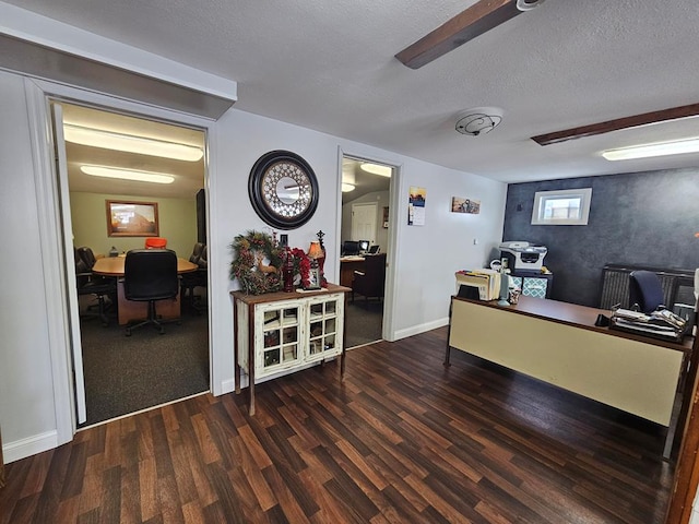 office area with baseboards, a textured ceiling, and wood finished floors