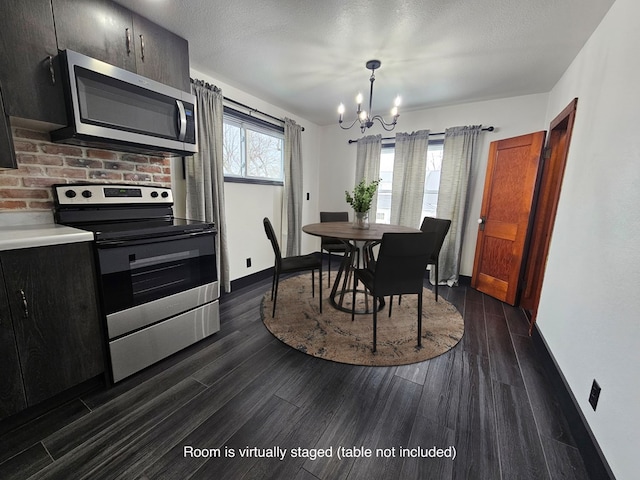 dining space featuring dark wood-style floors, a chandelier, and a textured ceiling