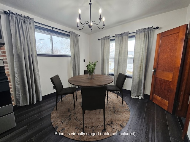 dining area with dark wood-style flooring, a notable chandelier, and baseboards