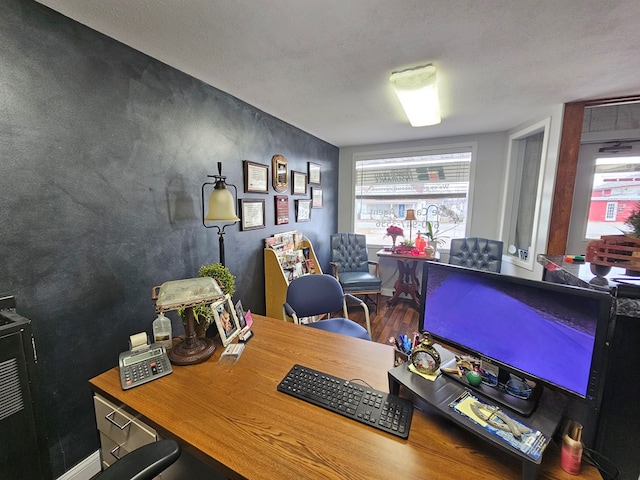 office space featuring baseboards and wood finished floors