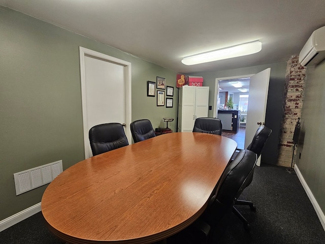home office featuring a wall mounted air conditioner, baseboards, and visible vents