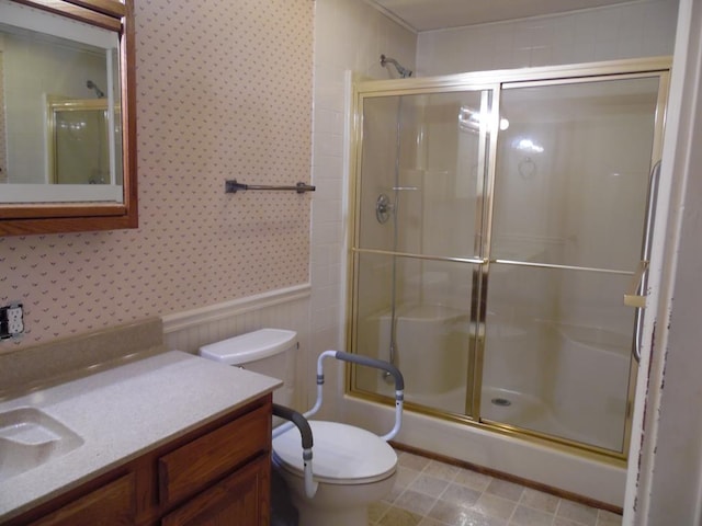 bathroom with vanity, toilet, and walk in shower