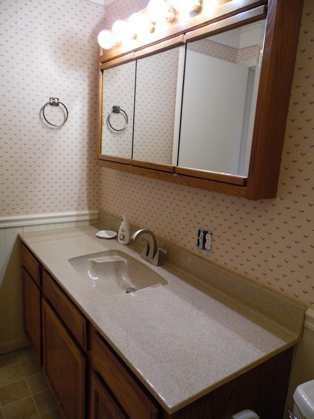 bathroom featuring tile patterned flooring and vanity