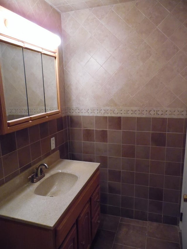 bathroom with vanity and tile walls