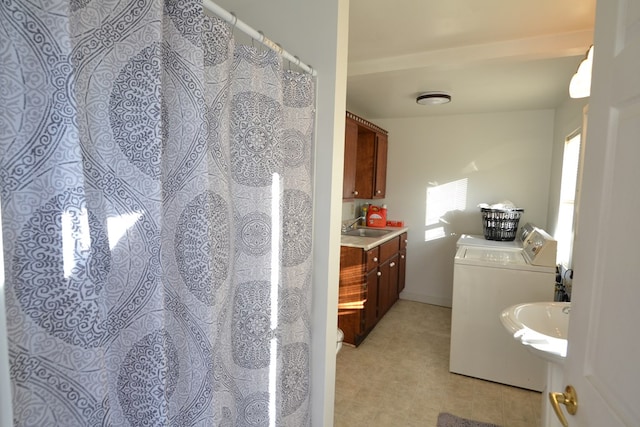 bathroom featuring vanity and washer and clothes dryer