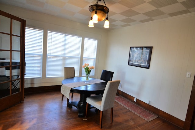 dining space with a notable chandelier and dark hardwood / wood-style floors