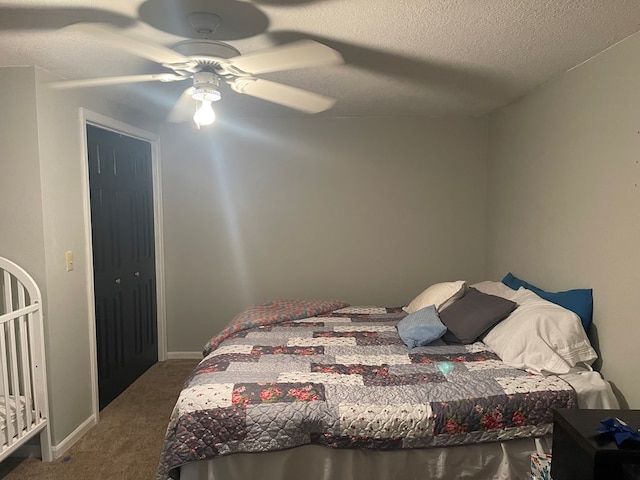 carpeted bedroom with a textured ceiling, a closet, and ceiling fan