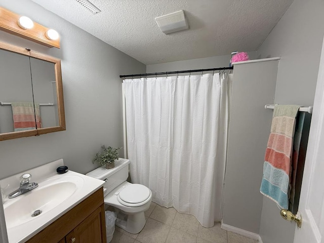 full bathroom with tile patterned flooring, vanity, a textured ceiling, and toilet